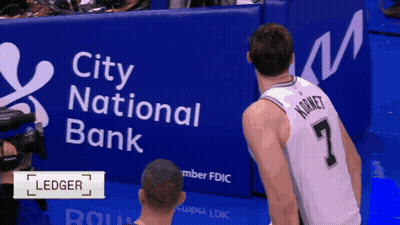 Kornet Is Standing In Front Of A City National Bank Banner GIF