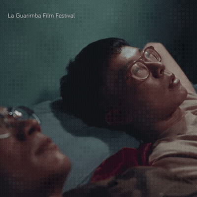 La Guarimba Film Festival Poster Two Men Laying On Bed GIF
