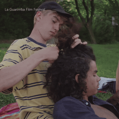 La Guarimba Film Festival Poster Two Young Men In Grass GIF