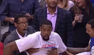 LA T-Shirt Man Held By Suit At Basketball Game GIF