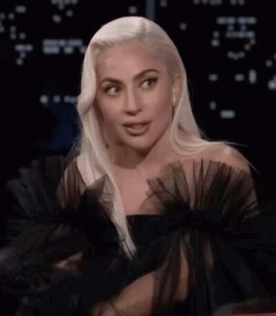 Lady Gaga In Black Dress With Ruffled Sleeves And Earrings GIF