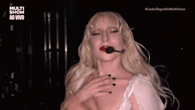 Lady Gaga In Black Dress With Ruffled Sleeves And Earrings GIF