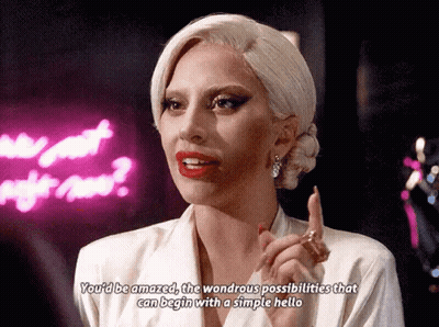 Lady Gaga Says You'd Be Amazed The Wondrous Possibilities That Can Begin With A Simple Hello In Front Of Neon Sign GIF