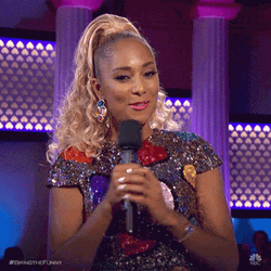 Lady Host Holding Microphone Presents Heart Hands GIF