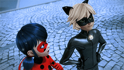 Ladybug And Cat Noir Standing On Cobblestone Street GIF