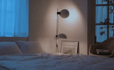 Lamp On Bed Next To Book Loewe GIF