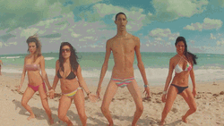 Lanky Man Dancing With Girls On Beach GIF