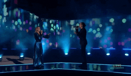 Lanky Man Sings On Stage GIF