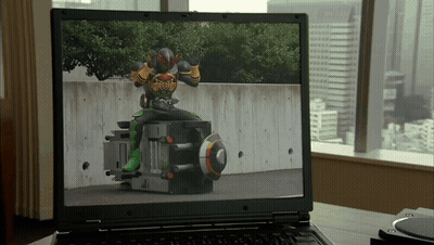 Laptop Showing Man In Superhero Costume GIF