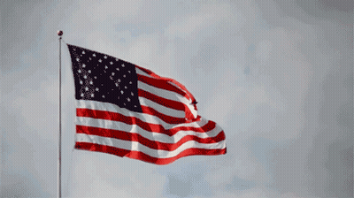 Large American Flag Flying In Wind GIF