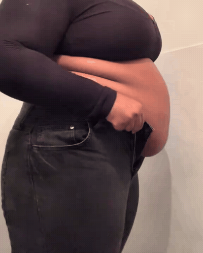 Large-Bellied Woman In Black Jeans And Crop Top GIF