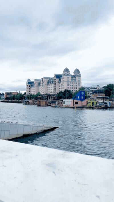 Large Building Behind Water With Boats GIF