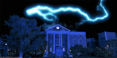 Large Building With Clock And Lightning GIF