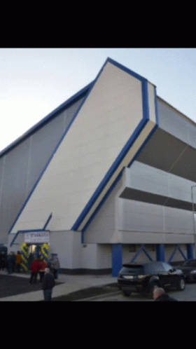 Large Building With Stadium Sign GIF