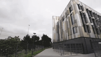 Large Building With Windows And Fence GIF