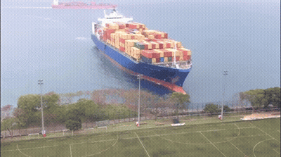 Large Container Ship Floating In Ocean GIF
