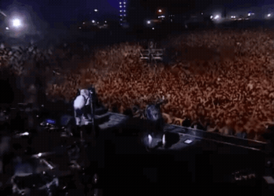 Large Crowd Gathered In Dark Room GIF