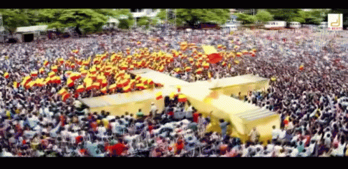 Large Crowd In Stadium With Yellow Cross GIF