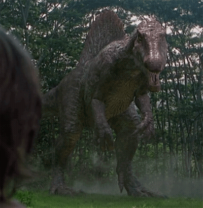 Large Dinosaur Standing In Grass GIF