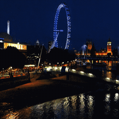 Large Ferris Wheel Lit Up At Night In City GIF