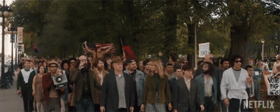 Large Group Marching With Netflix Sign GIF