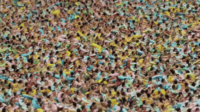 Large Group Of People Swimming In Pool With Floats GIF