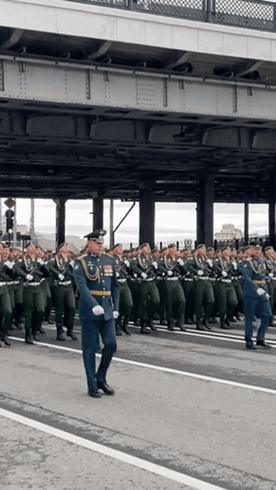 Large Group Of Soldiers Marching Down Street GIF