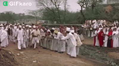 Large Group On Dirt Road In Field GIF