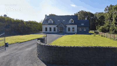 Large House With Stone Wall And Driveway GIF
