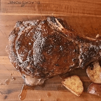 Large Meat On Cutting Board With Potatoes GIF