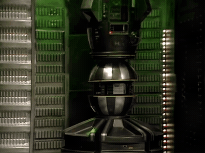 Large Metal Object With M On Green Wall GIF