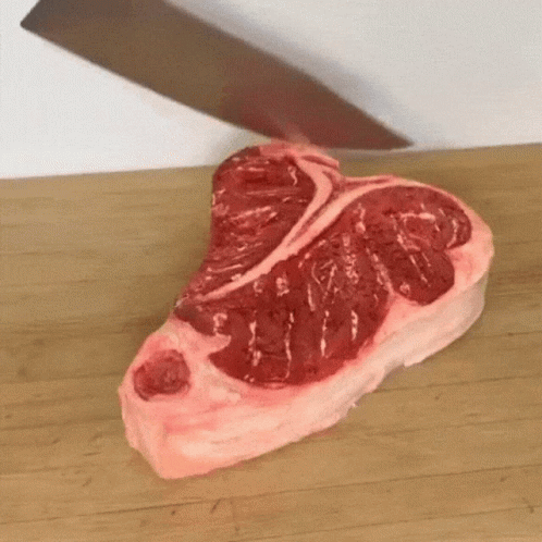 Large Piece Of Meat Being Cut On Cutting Board GIF