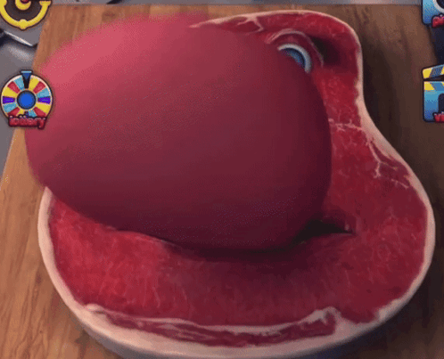 Large Piece Of Meat With Face On Cutting Board GIF