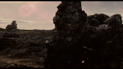 Large Rock In Desert With Pink Sun GIF