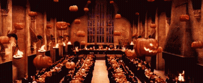 Large Room With Pumpkins Hanging From Ceiling GIF