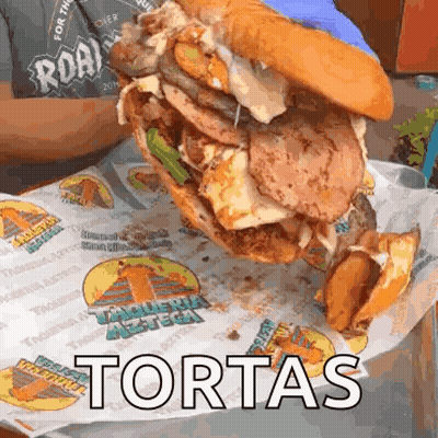 Large Sandwich With Toppings Saying Tortas GIF