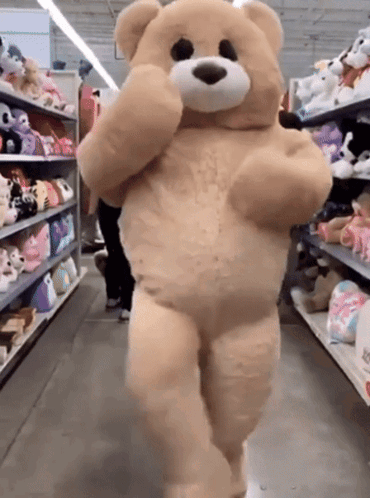 Large Teddy Bear Walking In Store Aisle GIF