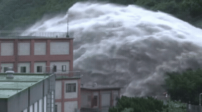 Large Waterfall Flowing Down Building GIF