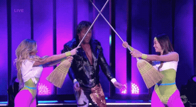 Leather Jacket Man Surrounded By Women With Brooms GIF