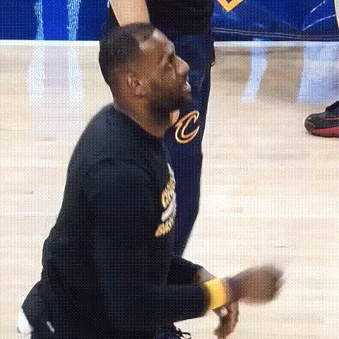 Lebron James Is Kneeling Down On The Court While A Man Stands Behind Him . GIF