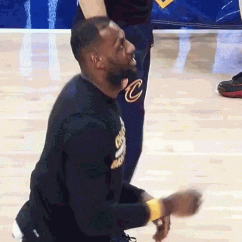 Lebron James Is Kneeling Down On The Court While Wearing A Cleveland Cavaliers Shirt GIF