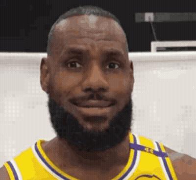Lebron James Is Wearing A Yellow And Purple Jersey And Smiling . GIF
