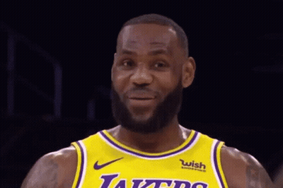 Lebron James Is Wearing A Yellow And Purple Lakers Jersey . GIF