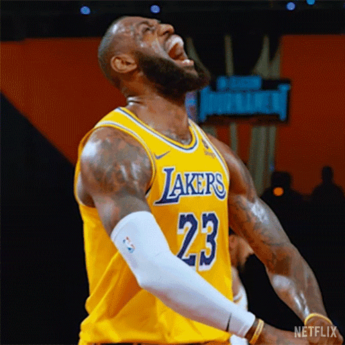 Lebron James Is Wearing A Yellow Lakers Jersey And Screaming During A Basketball Game . GIF