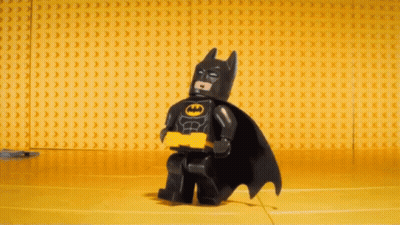 Lego Batman Standing In Front Of Yellow Bricks GIF