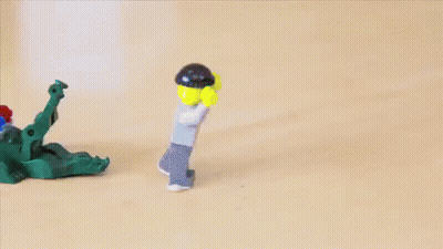 Lego Figure With Green Face Behind Fence