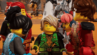 Lego Figures Gathered Around Boy In Green Vest GIF