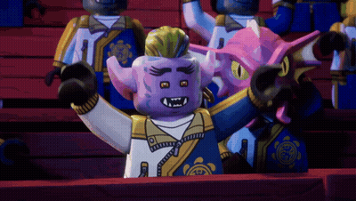 Lego Figures Sitting In Stadium Including Purple Figure With Horns GIF