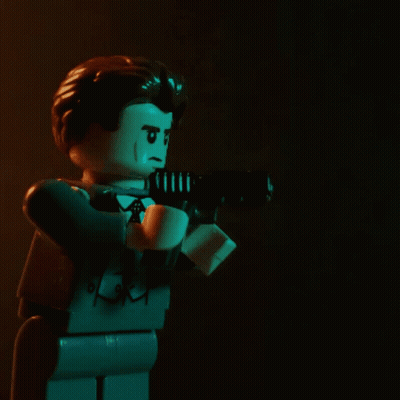 Lego Man Holding Gun With White Arrow GIF