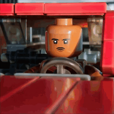 Lego Man With Mustache Driving Red Vehicle GIF